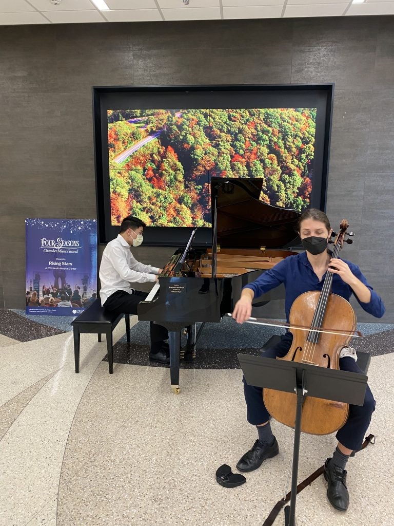 Cellist Frankie Carr and pianist Zhu Wang perform in the ECU Health Medical Center as part of Four Seasons Rising Stars @ ECU Health.