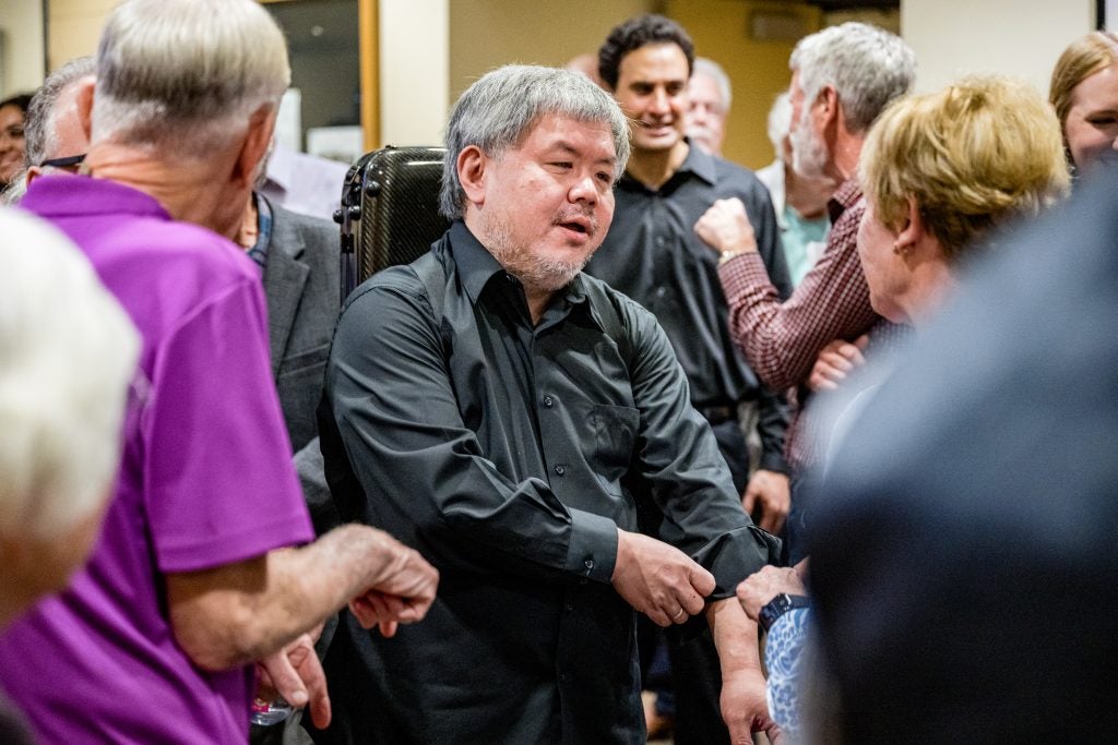Violinist Xiao-Dong Wang speaks with patrons after a Signature Series concert in Greenville.