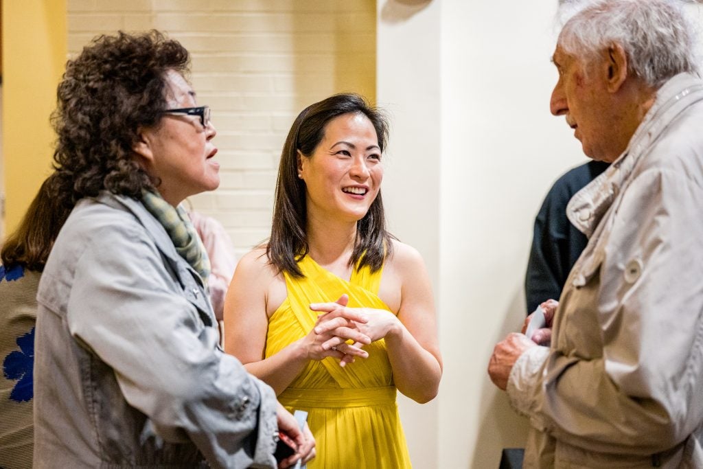 Violinist Hye-Jin Kim speaks with patrons after a Signature Series concert in Greenville.